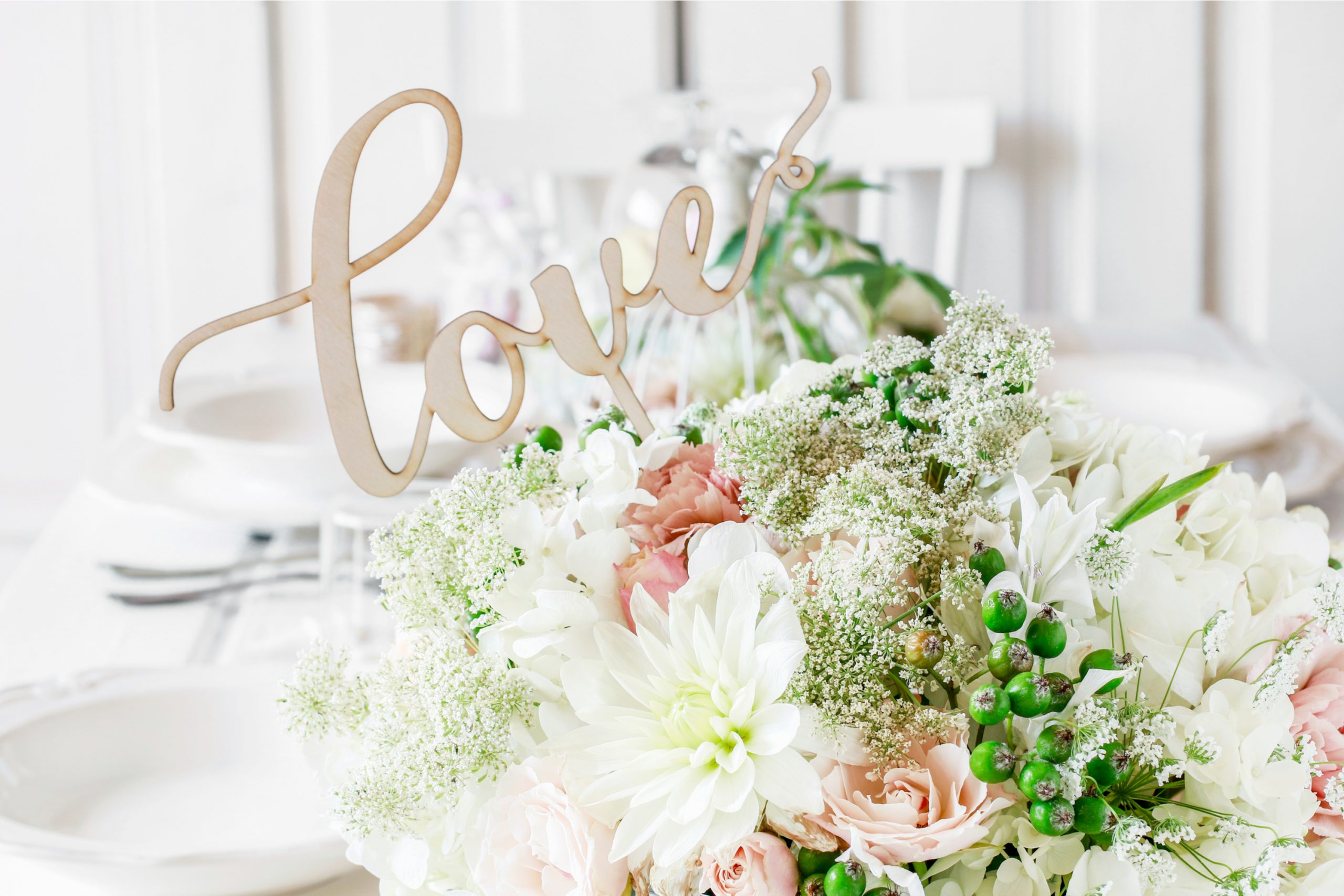 A stunning bouquet of pink and white flowers in a pitcher makes for simple centerpieces with a little bit of flair.