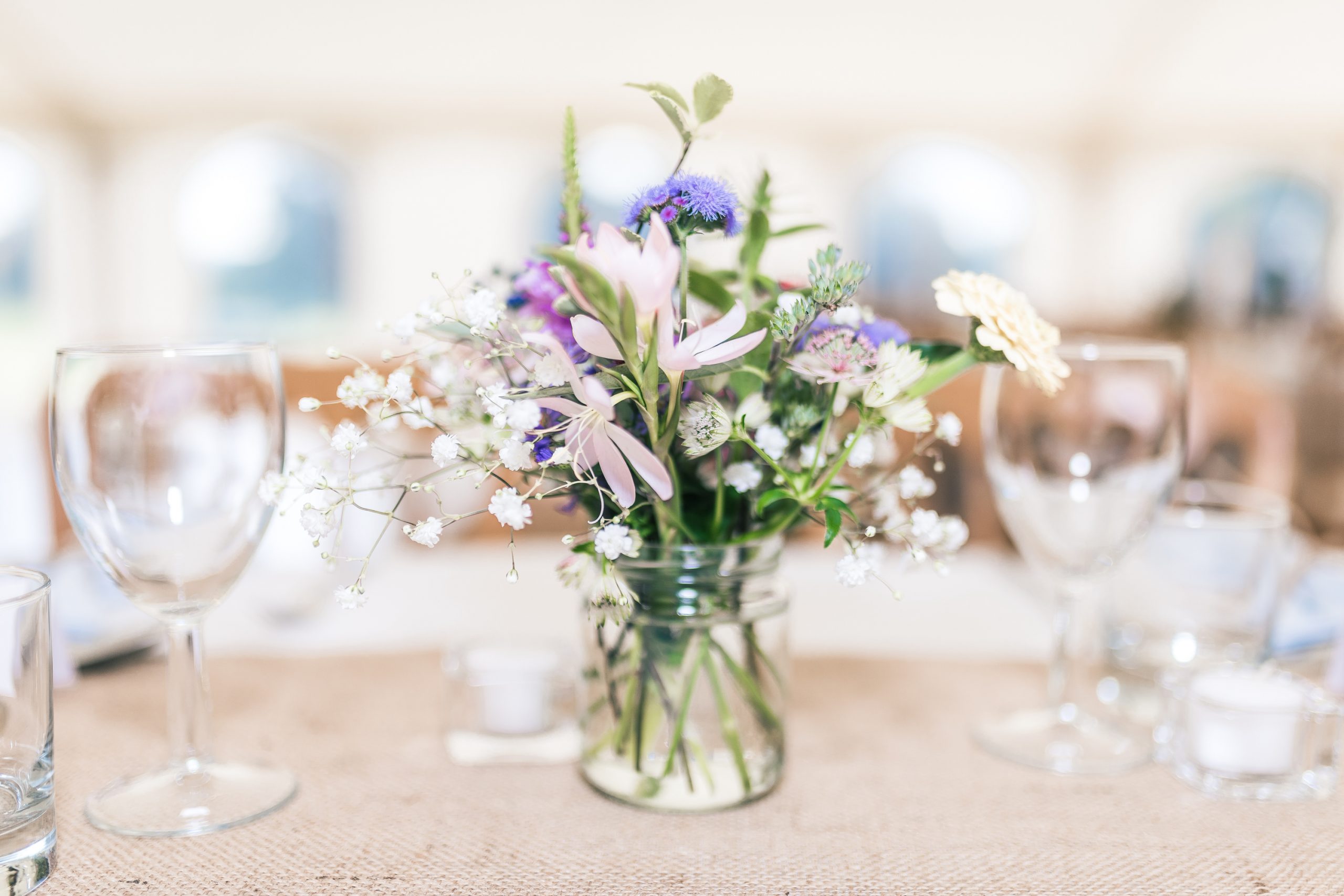 A gorgeous bouquet of delicate flowers in a mason jar makes beautiful simple centerpieces for any event.