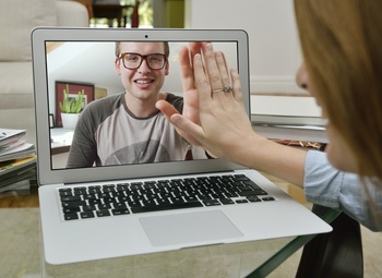 Couple touching hands over Skype.