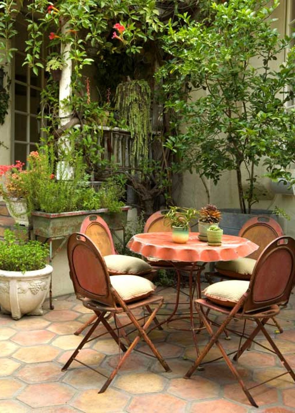Beautiful-patio-dining-area-with-rustic-metal-chairs-and-small-round-table-best-for-small-spaces.