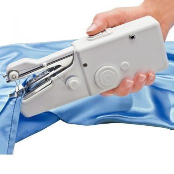 small white handheld sewing machine stitching a seam on blue fabric