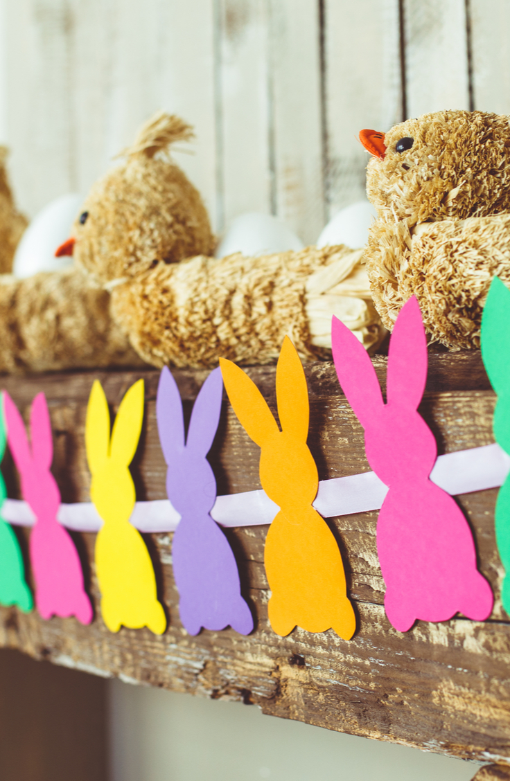 Spring Decorating Ideas- A mantel banner made with paper bunnies in random colors of pink, orange, purple, yellow and green. 