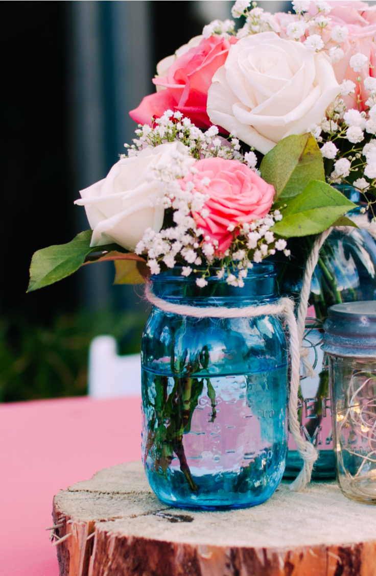 it's time for awesome DIY summer mason jar ideas! Mason jars are the perfect summertime centerpieces. Just add some flowers and tie some twine around them! 